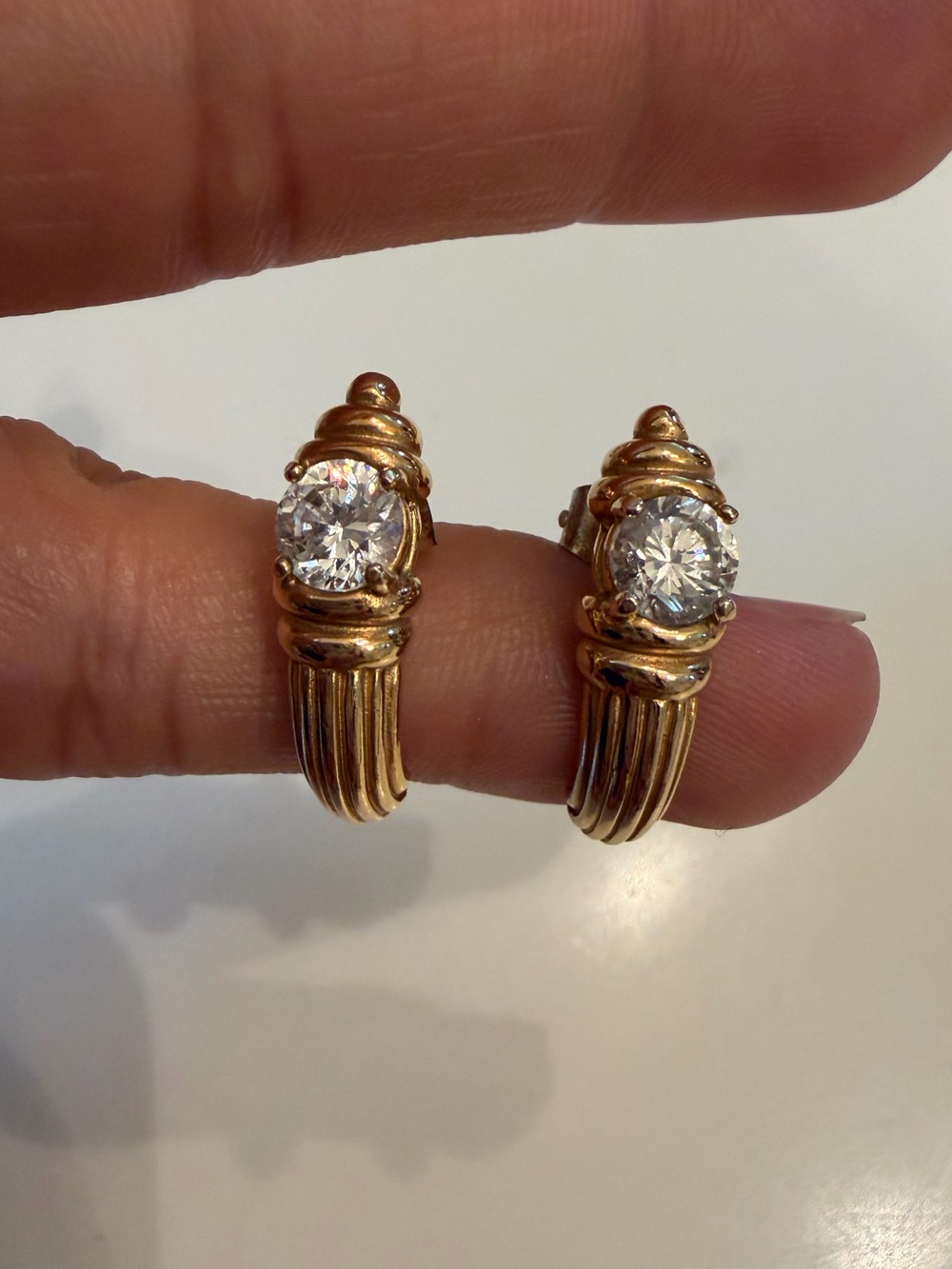 Krementz gold earrings with sparkly rhinestone center